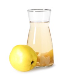 Photo of Tasty quince drink in glass carafe and fresh fruit isolated on white