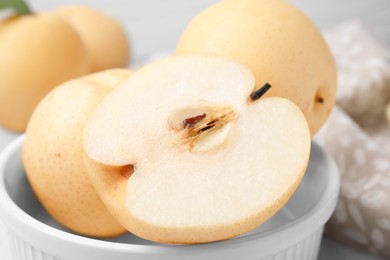 Photo of Bowl with delicious apple pears, closeup view