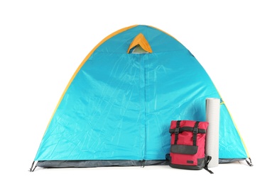 Photo of Colorful camping tent, backpack and mat on white background