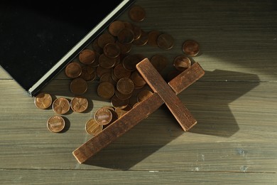 Photo of Donate and give concept. Coins, cross and Bible on wooden table, flat lay