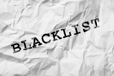Black word Blacklist on crumpled white paper