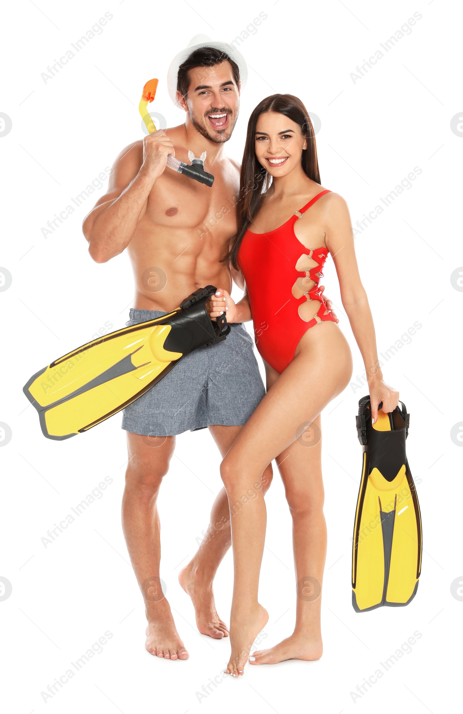 Photo of Young attractive couple in beachwear with snorkel and flippers on white background