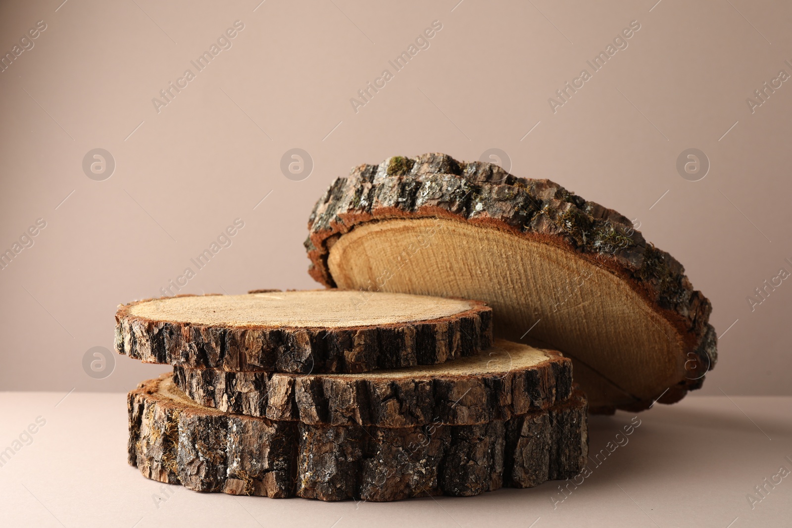 Photo of Presentation for product. Wooden stumps on beige background