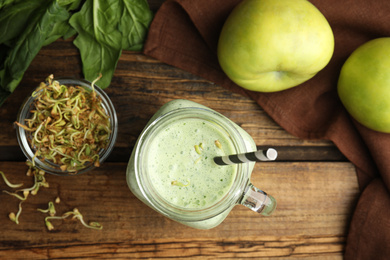 Photo of Flat lay composition with green buckwheat smoothie on wooden table