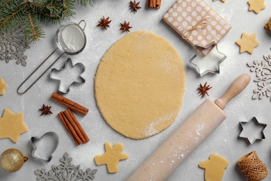 Photo of Composition with dough for Christmas cookies on light table, top view
