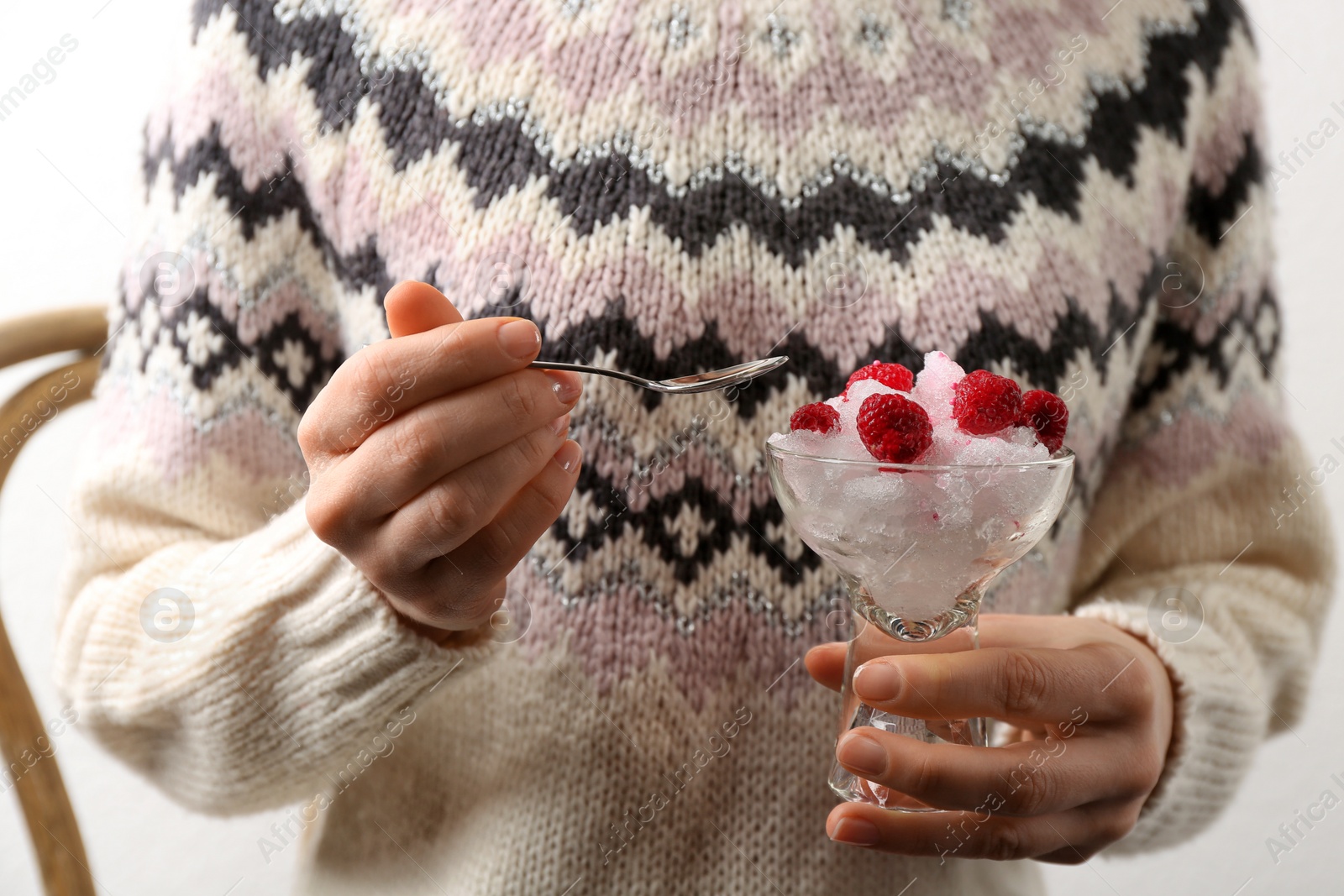 Photo of Woman eating tasty snow ice cream dessert, closeup