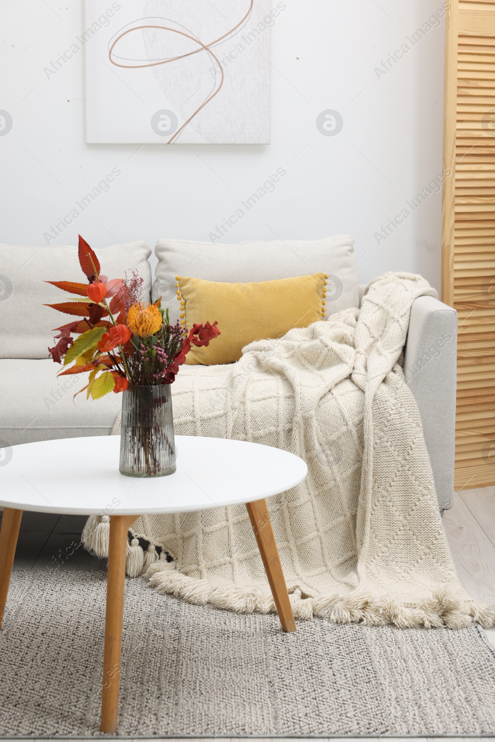 Photo of Living room with coffee table and comfortable sofa. Stylish interior design