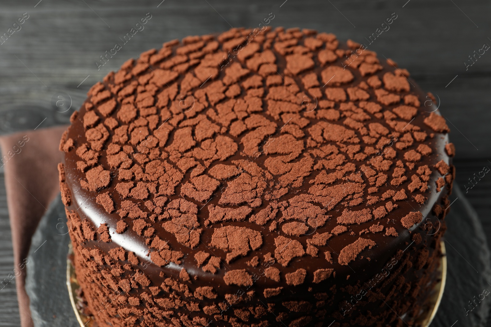 Photo of Delicious chocolate truffle cake on table, closeup