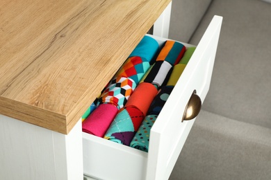 Photo of Drawer with different colorful socks indoors