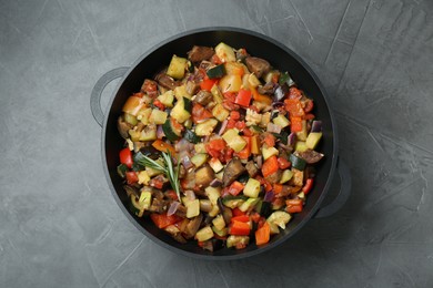 Photo of Delicious ratatouille in baking dish on grey table, top view