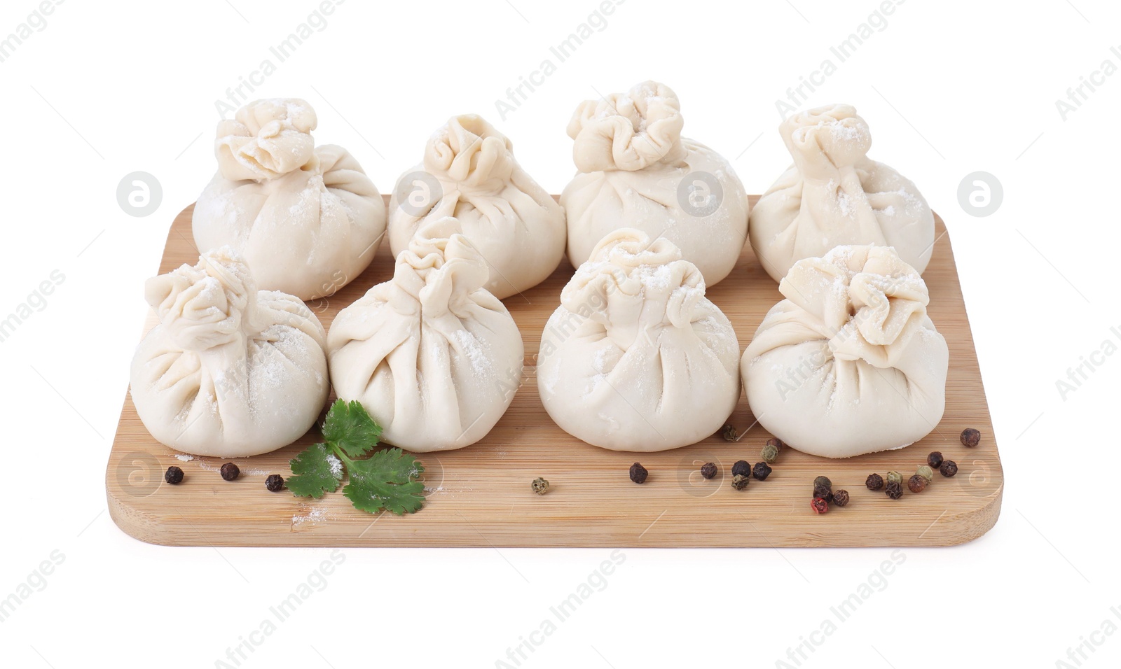 Photo of Uncooked khinkali (dumplings) and spices isolated on white. Georgian cuisine