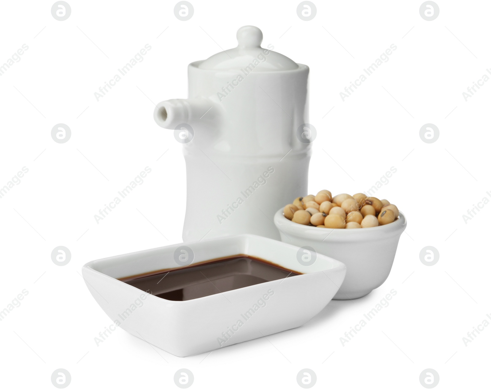 Photo of Tableware with soy sauce and beans on white background