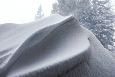 Photo of Beautiful snowdrift outdoors, closeup view/ Winter season