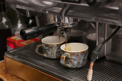 Photo of Preparing fresh aromatic coffee using modern machine at cafe