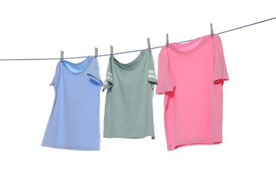 Photo of Different clothes drying on washing line against white background