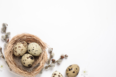 Photo of Flat lay composition with quail eggs on white background, space for text. Easter celebration
