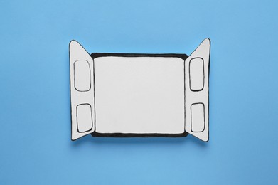 Open paper window frame on light blue background. Space for text