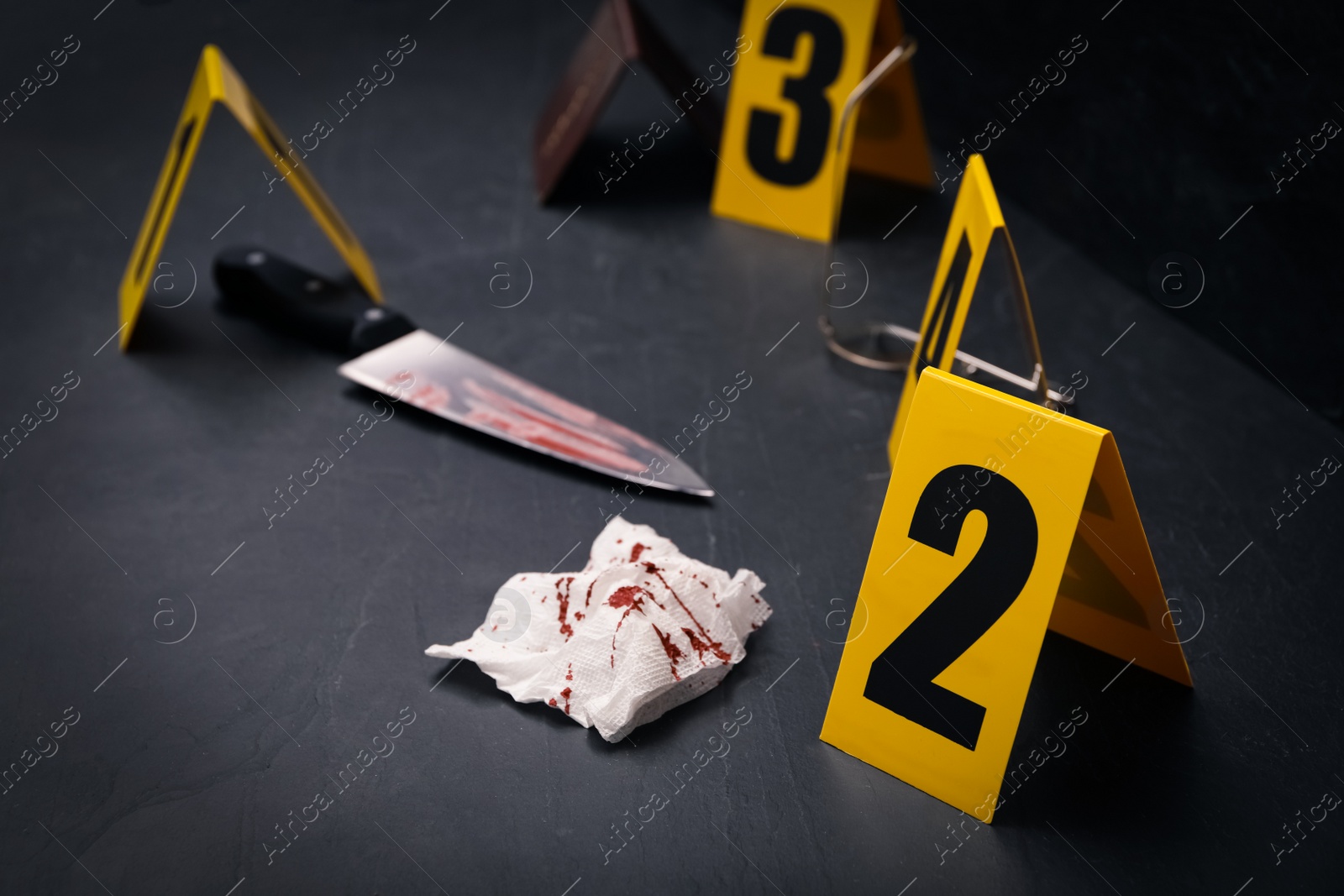 Photo of Crime scene markers and evidences on black background