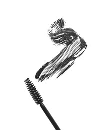 Photo of Smear of mascara and applicator isolated on white, top view