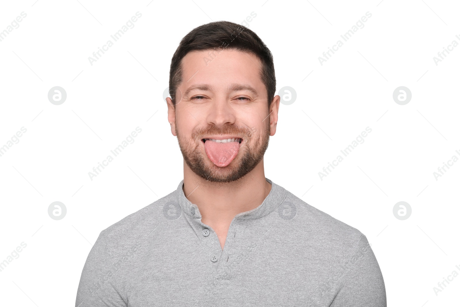 Photo of Happy man showing his tongue on white background