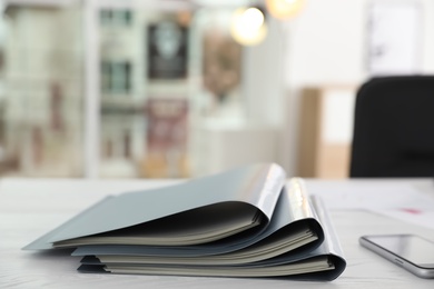 Photo of Stack of folders with documents on office table. Space for text