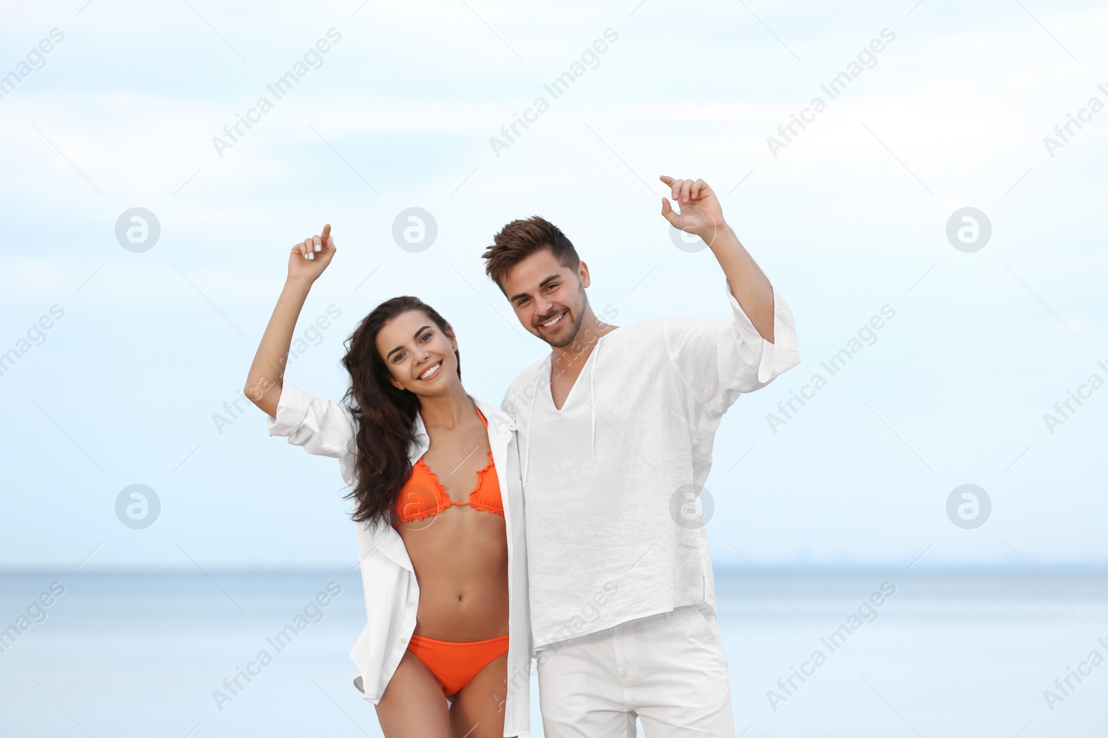 Photo of Happy young couple spending time together on beach