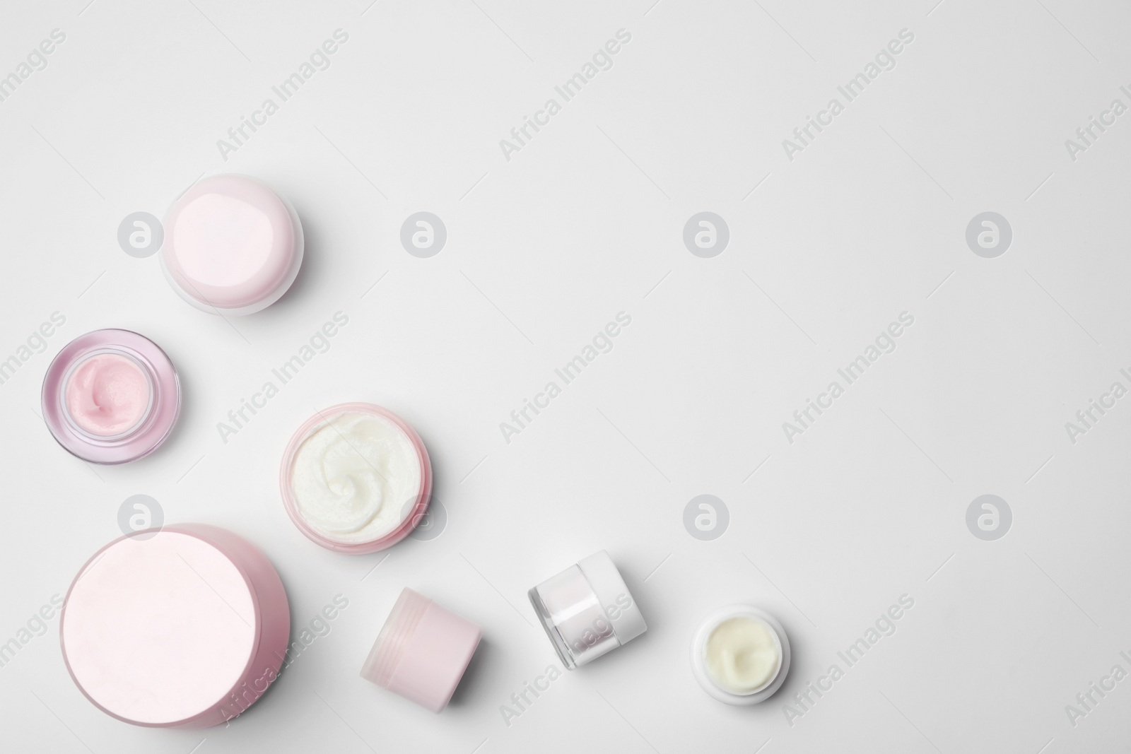 Photo of Flat lay composition with cosmetic products on light background