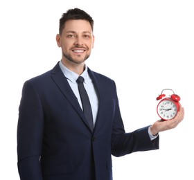 Happy businessman holding alarm clock on white background. Time management