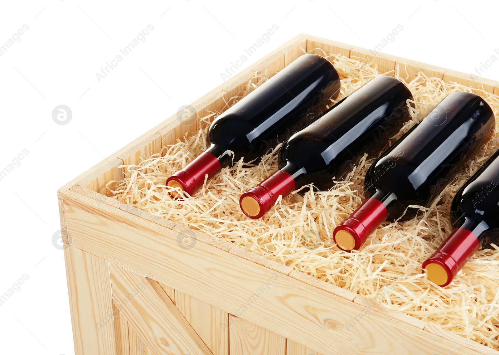 Photo of Wooden crate with bottles of wine isolated on white, closeup