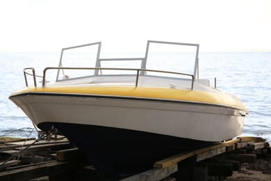 Moored boat on beach near sea outdoors