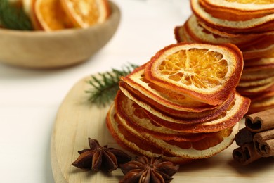 Dry orange slices., anise stars and cinnamon sticks on white table, closeup. Space for text