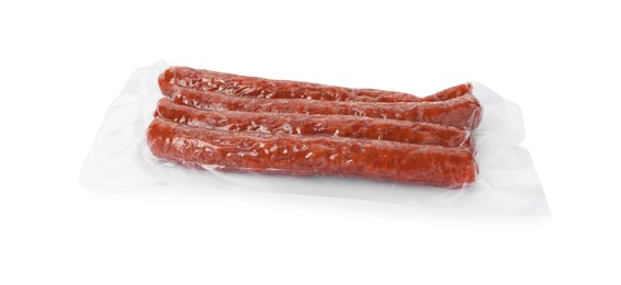 Photo of Pack of thin dry smoked sausages isolated on white