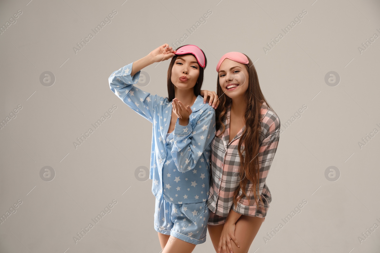 Photo of Beautiful women in pajamas on beige background. Bedtime