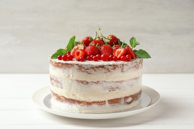 Delicious homemade cake with fresh berries on wooden table