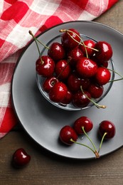 Wet red cherries on wooden table, flat lay