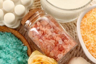 Photo of Flat lay composition with different types of aromatic sea salt on wicker mat