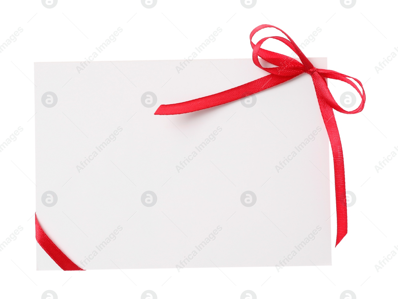 Photo of Blank card with red bow on white background, top view. Valentine's Day celebration