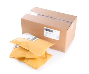 Photo of Padded envelopes and cardboard parcel on white background