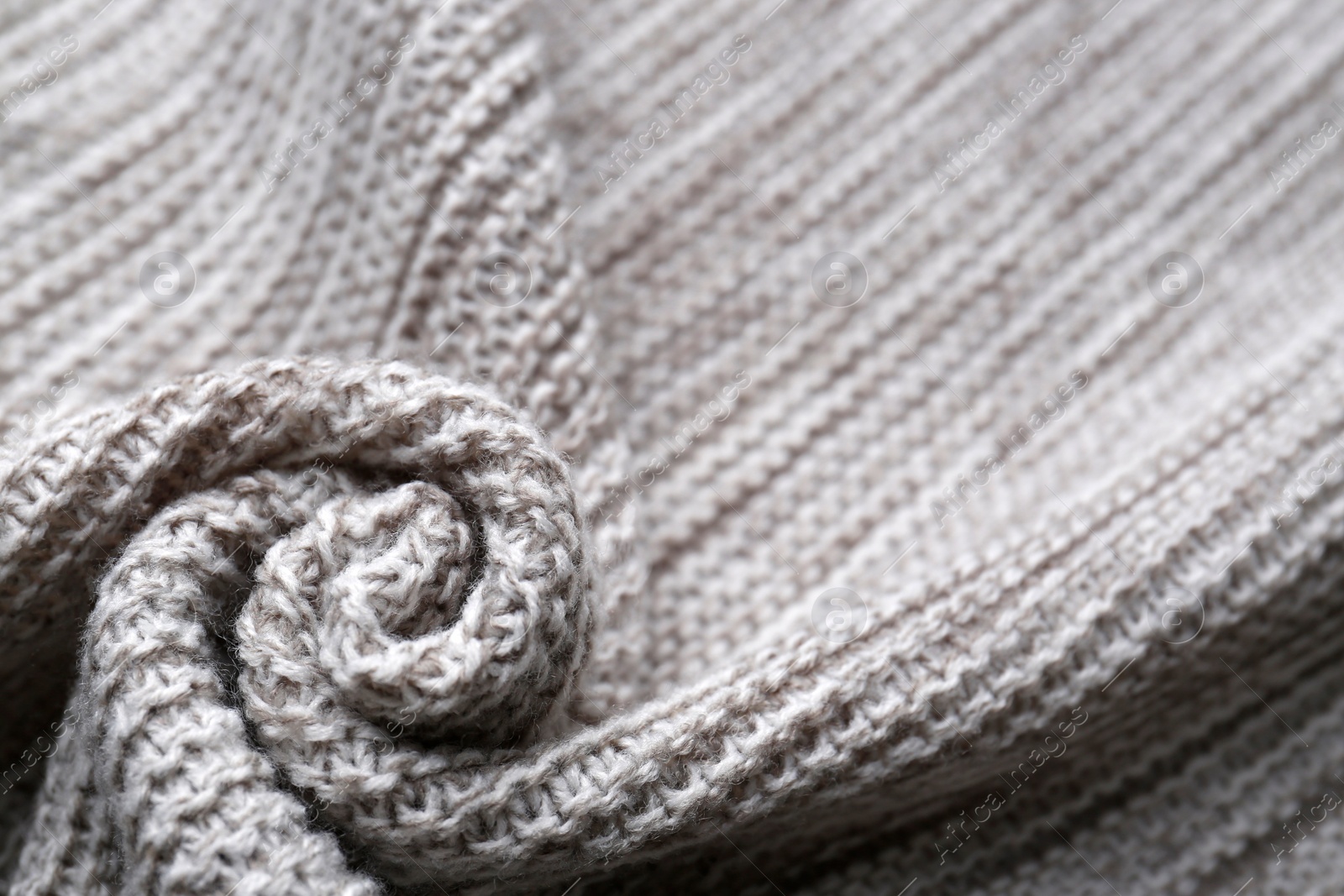 Photo of Beautiful grey knitted fabric as background, closeup