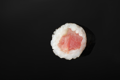Photo of Sushi roll with tuna on black background