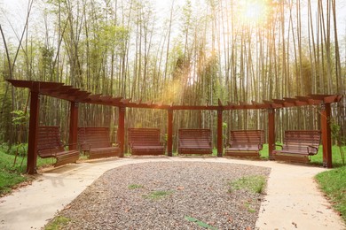 Photo of Beautiful brown swing set and bamboo in tranquil park