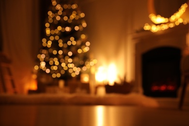 Blurred view of beautiful room interior with Christmas tree and fireplace