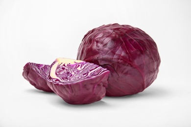 Photo of Whole and sliced red cabbage on white background