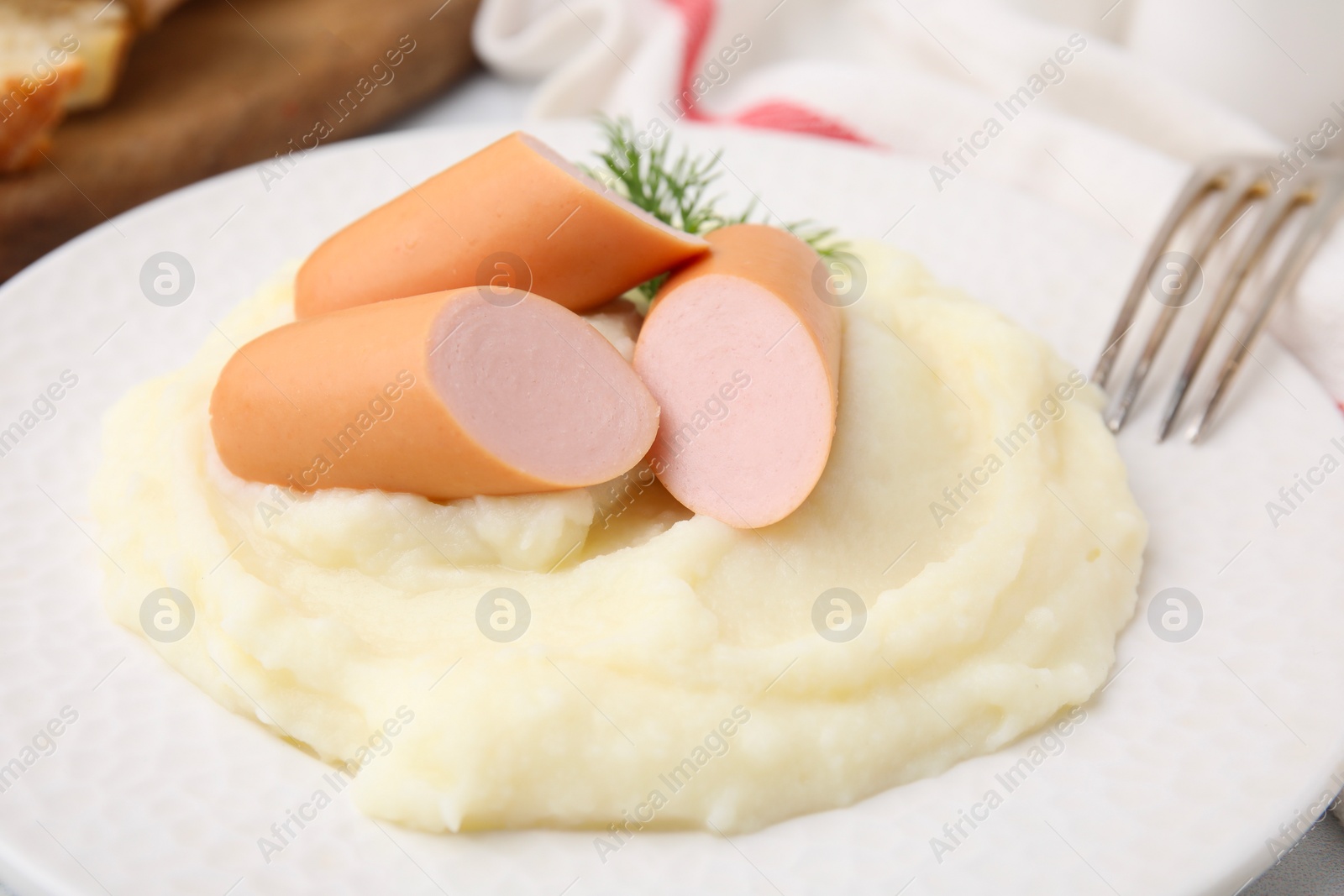 Photo of Delicious boiled sausages and mashed potato on table, closeup