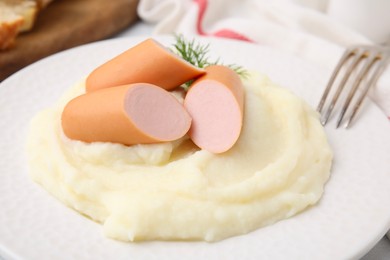 Delicious boiled sausages and mashed potato on table, closeup