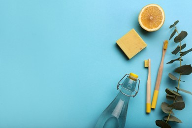 Photo of Flat lay composition with eco friendly products on turquoise background, space for text