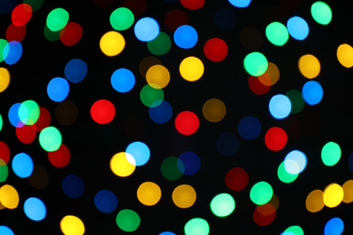 Photo of Multicolor blurred lights on black background. Bokeh effect