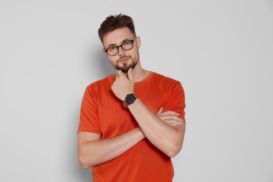 Photo of Handsome man in eyeglasses on light grey background