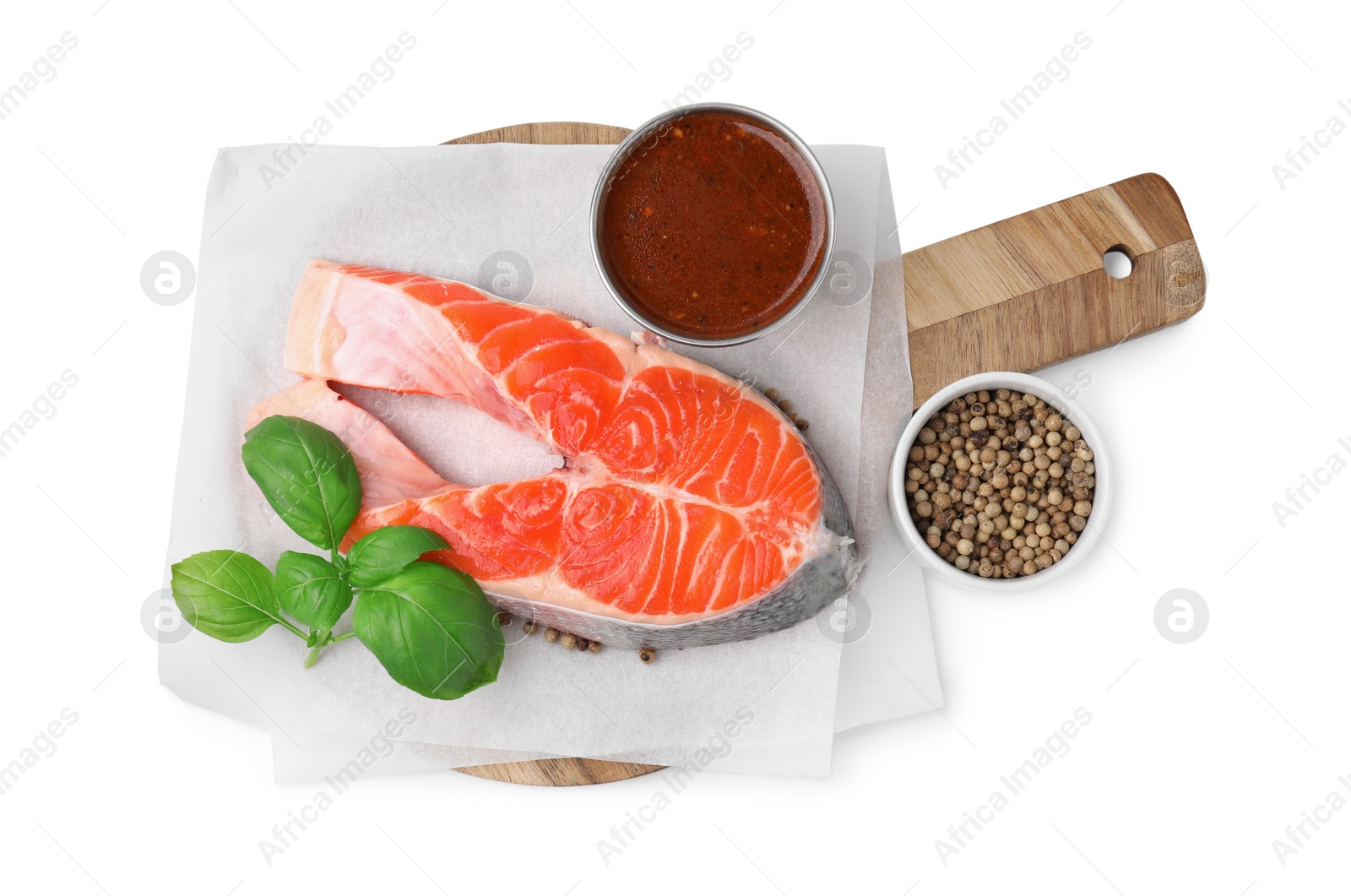 Photo of Fresh fish, basil, peppercorns and marinade isolated on white, top view