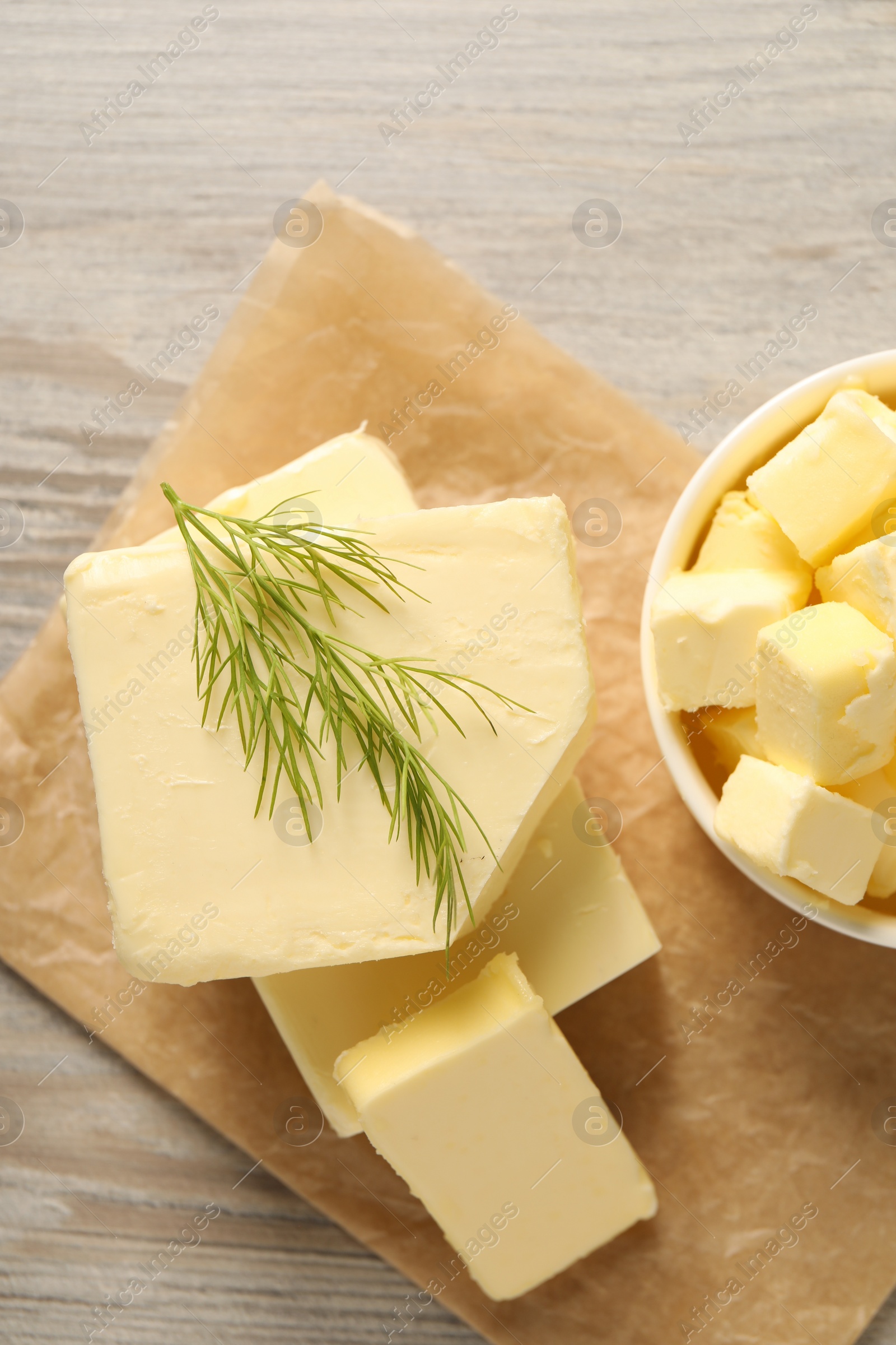 Photo of Tasty butter with dill on wooden table, top view